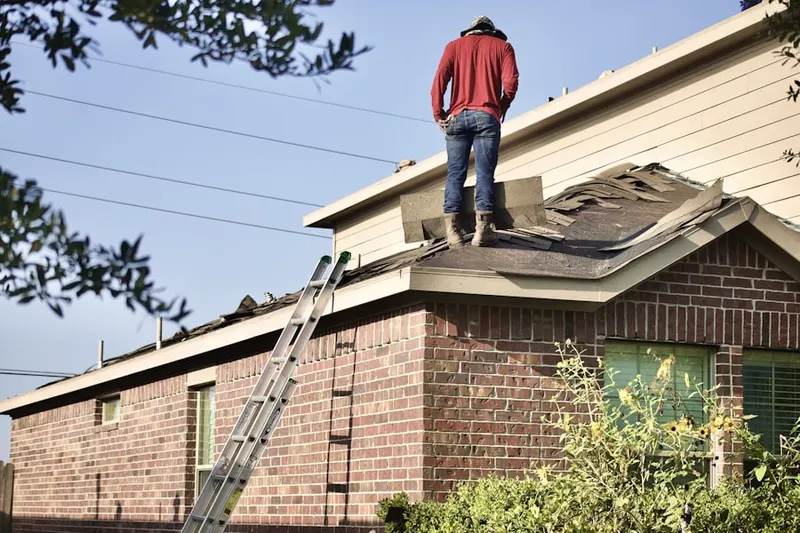 Professional roofer working on a residential roof in East Grossdale